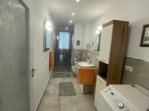 a bathroom with a sink and a toilet and a shower at Ferienwohnung Sonnenhöhe in Greiz +14 photos