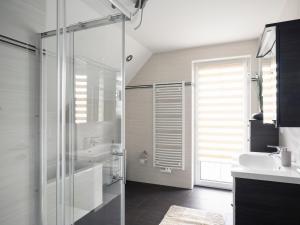 a bathroom with a glass shower and a sink at Gästehaus Lean in Potsdam +14 photos
