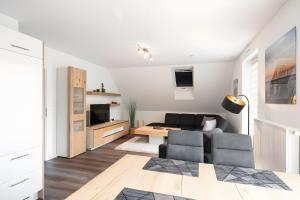 a living room with a couch and a table at Gästehaus Lean in Potsdam