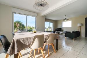 a dining room with a table and chairs at Maison Ty Rhuys avec piscine in Saint-Gildas-de-Rhuys