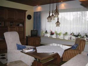 a living room with a table and chairs and a window at Ferienhaus Ockholm in Ockholm