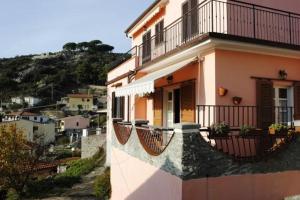 a building with balconies and a view of a city at Appartamento Seccheto Mare in Seccheto