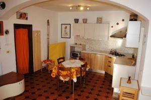 a kitchen with a table with a yellow table cloth on it at Appartamento Seccheto Mare in Seccheto