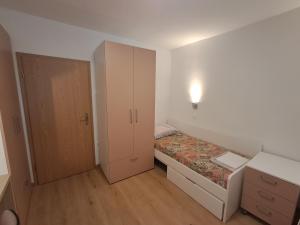 a small bedroom with a bed and a cabinet at Mediterranean Rooms Koper in Koper