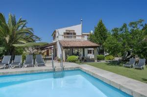 a swimming pool in front of a house at Can Toni in El Port