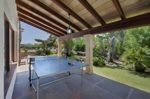 a ping pong table on the patio of a house at Can Toni in El Port