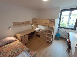 a dorm room with a desk and bunk beds at Mediterranean Rooms Koper in Koper
