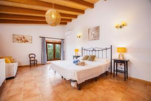 a bedroom with a large bed and a couch at Na Amera Ref 225 in Campos +25 photos