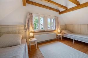 a bedroom with two beds and two windows at Grüner-Seppel in Rodalben