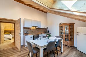 a kitchen and dining room with a table and chairs at Wohnung Brauneck in Gaißach