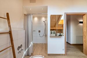 a bathroom with a shower and a shower curtain at Wohnung Brauneck in Gaißach +25 photos