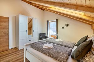 a bedroom with two beds and a loft at Wohnung Brauneck in Gaißach