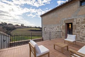a patio with a view of the countryside from a house at Cal Trumfet in Caserras