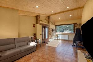 a living room with a couch and a table at Cal Trumfet in Caserras