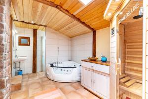 a bathroom with a tub and a sink at Blockhaus Günther und Brigitte Serr in Lauf +25 photos