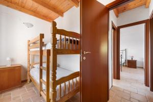 a room with two bunk beds in a house at Villa Is Sorrisi in Gonnesa