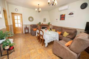 a living room with a couch and a table at Villa mis Raices in Castilblanco de los Arroyos