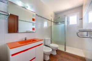 a bathroom with a sink and a toilet and a shower at Es Camp in Cala Saona +17 photos