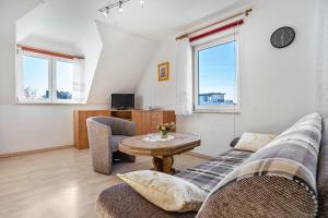 a living room with a couch and a table at Haus Arvert in Koserow