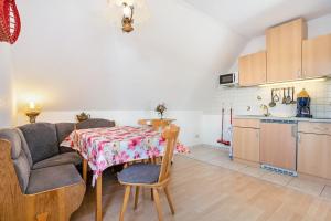 a living room with a table and a couch and a kitchen at Haus Arvert in Koserow