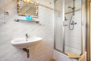 a bathroom with a sink and a shower at Haus Arvert in Koserow +37 photos
