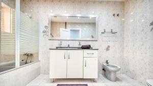 a bathroom with a sink and a toilet and a mirror at Costacabana - Villa Sarai in Lloret de Mar +8 photos