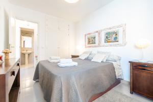 a bedroom with a bed with two towels on it at Taiko in Port de Pollensa