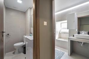 a bathroom with a toilet and a sink at Casa Sparto in Meganisi +25 photos
