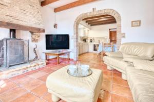 a living room with a couch and a fireplace at La Ferme in Razac-dʼEymet