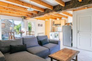 a living room with a couch and a table at Maison de vacances 4 pers in Saint-Just +12 photos