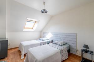 a bedroom with two beds and a television at Maison de vacances 4 pers in Saint-Just