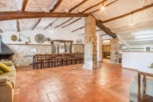 a large living room with a table and chairs at El Porxet in Navés