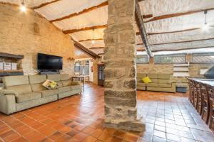 a large living room with a couch and a tv at El Porxet in Navés