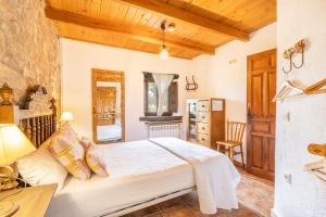 a bedroom with a bed and a table in a room at El Porxet in Navés +36 photos