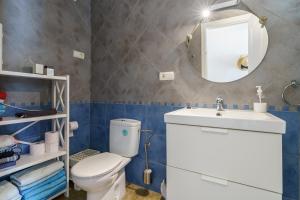 a bathroom with a toilet and a sink and a mirror at La Ponderosa 5 in Mijas Costa +20 photos