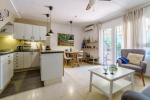 a kitchen and living room with a table at La Ponderosa 5 in Mijas Costa