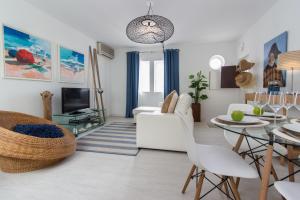 a living room with a white couch and a table at Beach And Mountain Apartment in Sesimbra