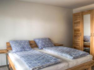 a bedroom with two beds with blue pillows at Alpenblick 1 in Lindau-Bodolz