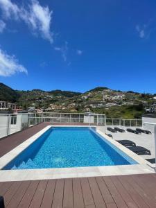 a swimming pool on the roof of a house at Casa Sol in Caniço