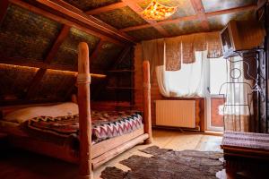 a bedroom with a bed in a wooden room at Sadyba Lileya in Verkhovyna
