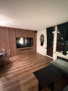 a living room with a flat screen tv on the wall at Design Apartment in Vesterbro with Large Balcony in Copenhagen