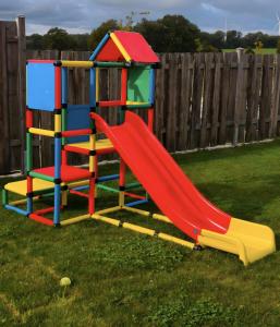 a playground with a slide in a yard at Ferienwohnung Efzeglück mit Pool in Homberg