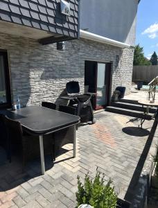 a patio with two tables and chairs on a brick patio at Ferienwohnung Efzeglück mit Pool in Homberg