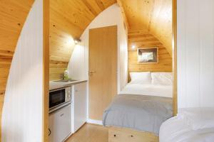 a bedroom with a bed in a small room at Cabanas do Alto da Coutada in Ponte de Lima