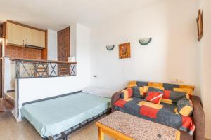 a living room with a couch and a table at Calpe primera linea con piscina in Casas de Torrat +14 photos