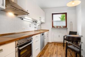 a kitchen with white cabinets and a counter top at Lieblingsnest in Grübels