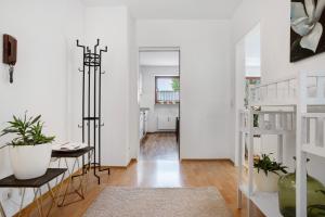 a living room with white walls and a staircase at Lieblingsnest in Grübels +17 photos