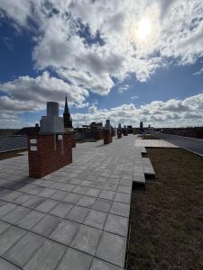 a group of benches sitting on top of a roof at Design Apartment in Vesterbro with Large Balcony in Copenhagen