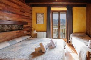 a bedroom with two beds with towels on them at Masia d'en cot in Puigcerdà