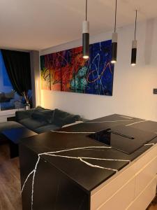 a living room with a couch and a painting on the wall at Design Apartment in Vesterbro with Large Balcony in Copenhagen